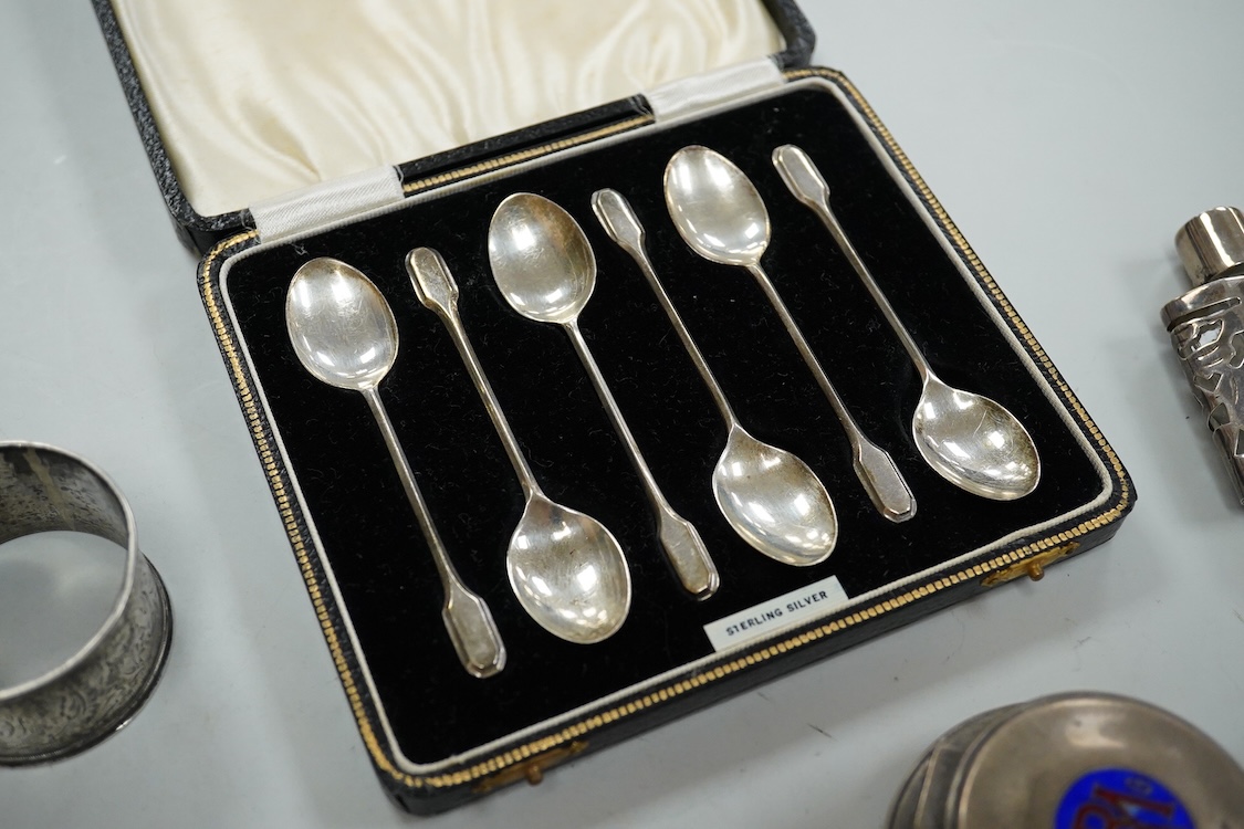 A collection of assorted small silver, including set of six 1930's coffee spoons, a mounted travelling pocket watch case, Victorian pepperette, mounted glass dwarf candlestick, enamelled powder box, Georgian stilton scoo